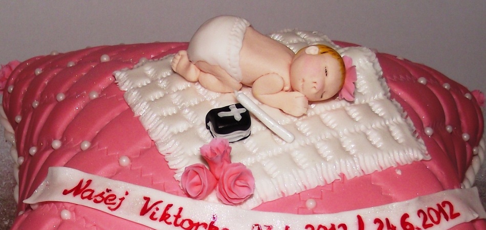 "Carved novelty christening pillow cake, accesorised with hand made decorations and sugar baby"