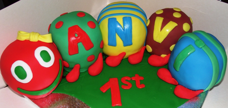 "Novelty decorated colorful caterpillar first birthday cake :)"